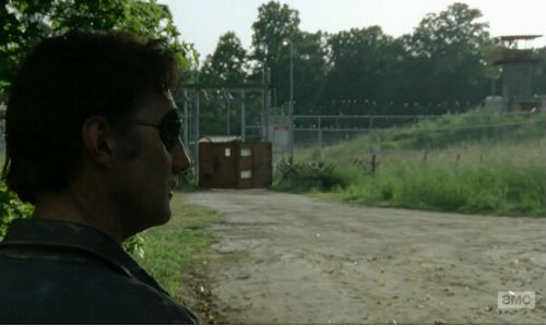 The Governor stares passively at the prison, any semblance of the man he yearned to be as dead as many members of his group would soon be (image via nurevues.com (c) AMC)