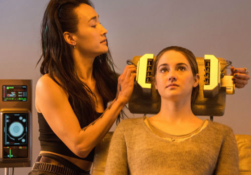 Tori Wu (Maggie Q), member of Dauntless, tattoo artist and one of the people who administer the aptitude test, becomes an unlikely ally of Tris, empathetic to the young woman's status thanks to the murder of her brother who was also divergent (image via Divergent official movie site)