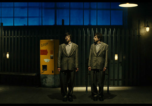 Eerily the same, and yet not at all, Simon James and James Simon are two sides of the same fractured psyche (image via The Double official movie site)