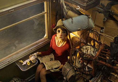 Surrounded by an avalanche of luggage, Madame Tutli-Putli finds herself drawing a series of disconnected but mysterious events onboard the train on which she's travelling with an intriguingly odd assortment of characters (image via Cartoon Brew)