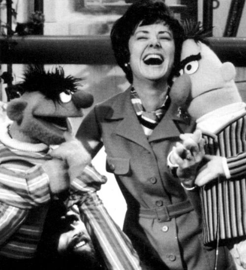 Joan Ganz Cooney shares a laugh with Ernie and Bert in the early days of Sesame Street (image via Muppet Wikia (c) Children's Television Workshop)