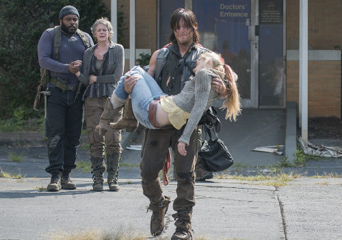 Bereft beyond words Daryl tenderly carries Beth's body out to her grieving sister who has just arrived full of hope for a reunion with the only living family member she has left (image via AMC/Gene Page)
