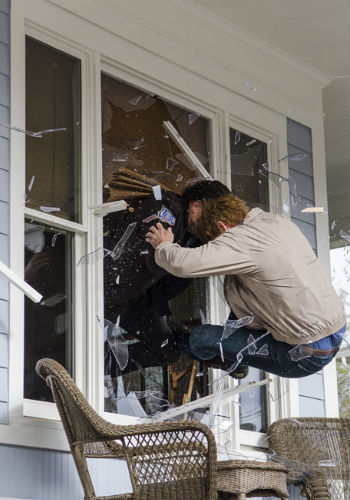 And out the window they go, Rick and Peter taking their manly physical banter a little too far (Photo by Gene Page/AMC)