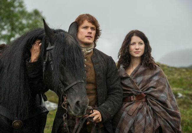Jamie and Claire look down upon Lallybroch, where a whole host of cultural potholes await the new wife of the Laird (image via Spoiler TV (c) Starz)