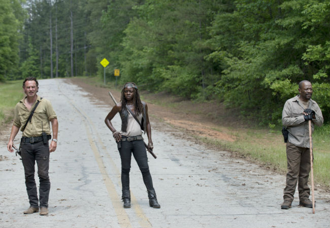 Rick, Michonne and Morgan pause during their daily constitutional to ponder their good fortune ... OR, and this is more likely, get ready to fight a HUGE number of walkers (image via The Young Folks (c) AMC)